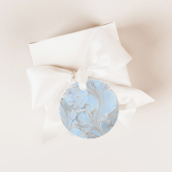 A beautifully wrapped gift with the 'Aquatic Elegance' sticker affixed as a charming gift tag, enhancing the overall presentation with its coordinating blue pattern and elegance