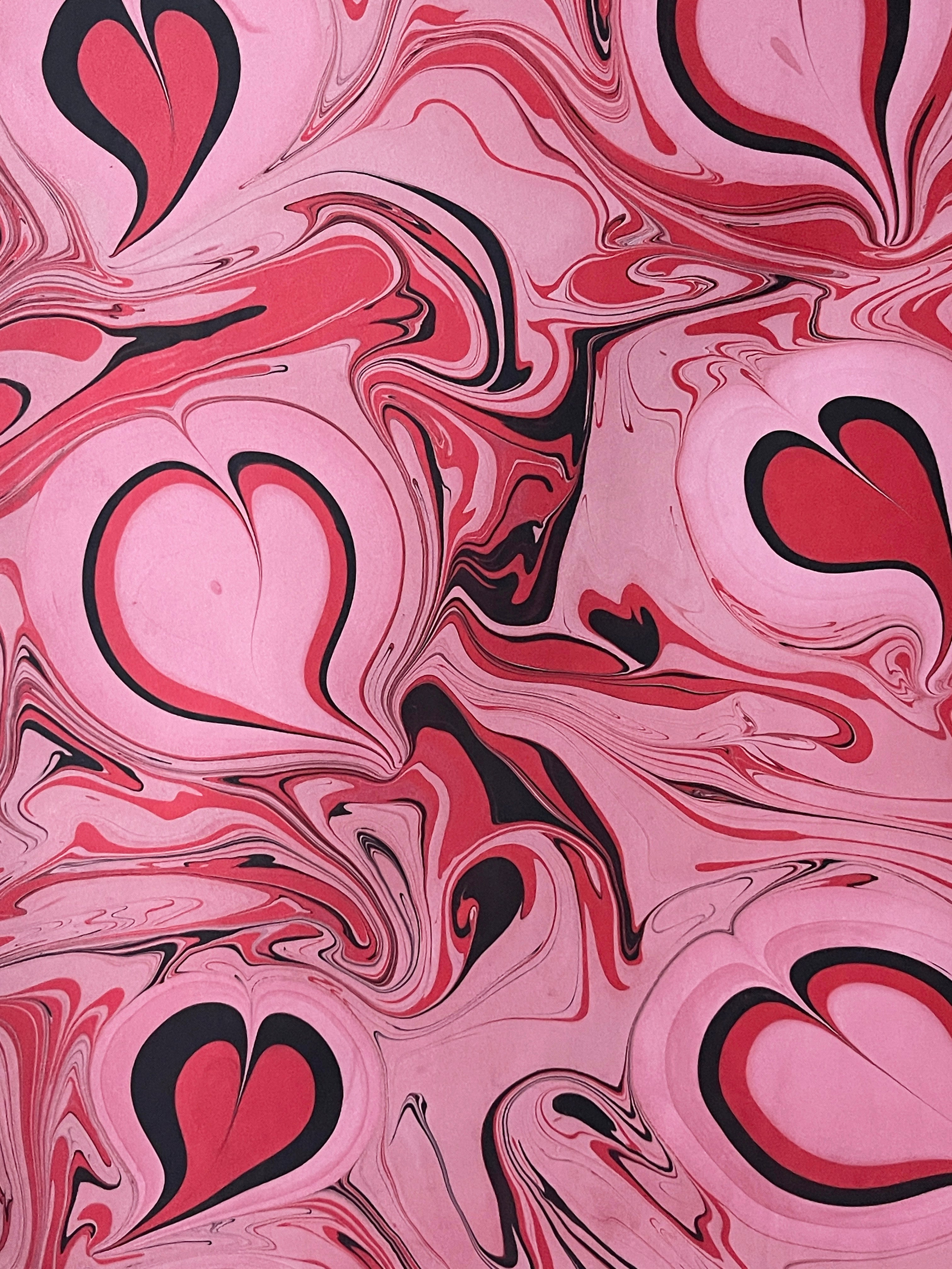 Organic design with pink, black, and white marbled pattern with heart shapes.