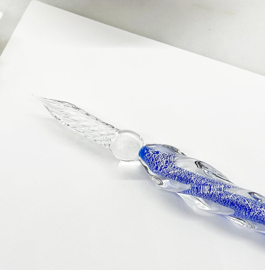 A cobalt blue glass pen, an elegant and stylish writing instrument for creative expression and fine writing